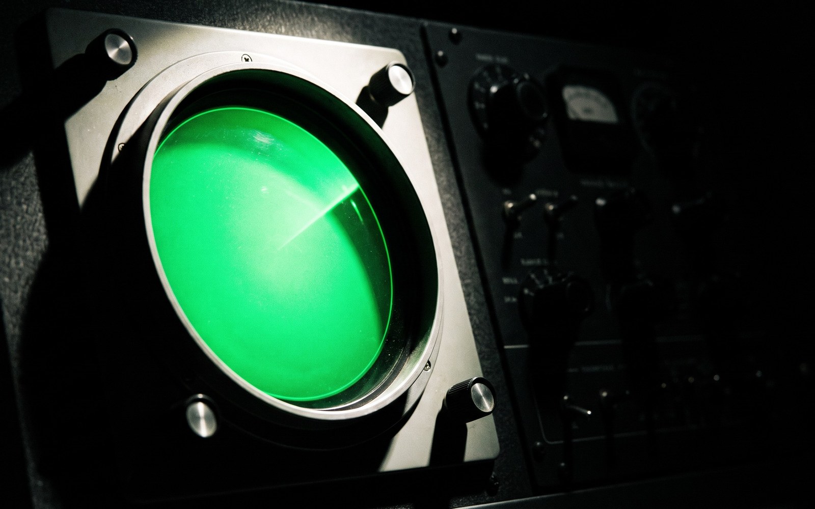 A vintage circular radar screen glowing green in a dark control room at night, one faint blip about to fade from the sweep