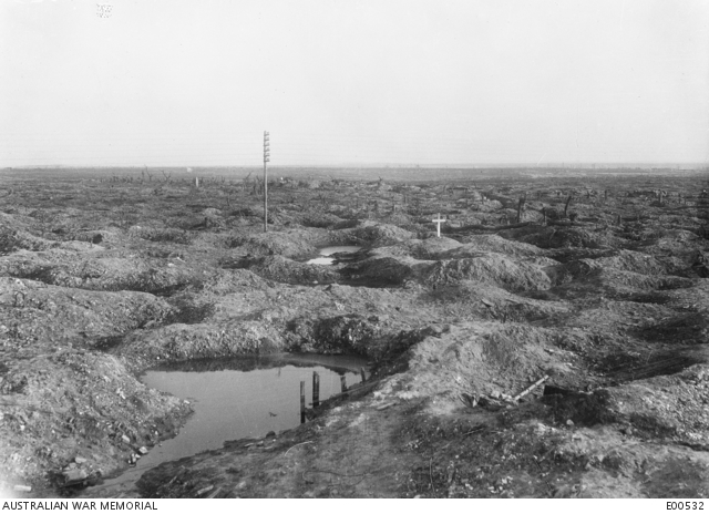 The isolated grave of an Australian officer amid the shattered, shell-cratered wasteland near Pozières, months after the fighting there, 1917.