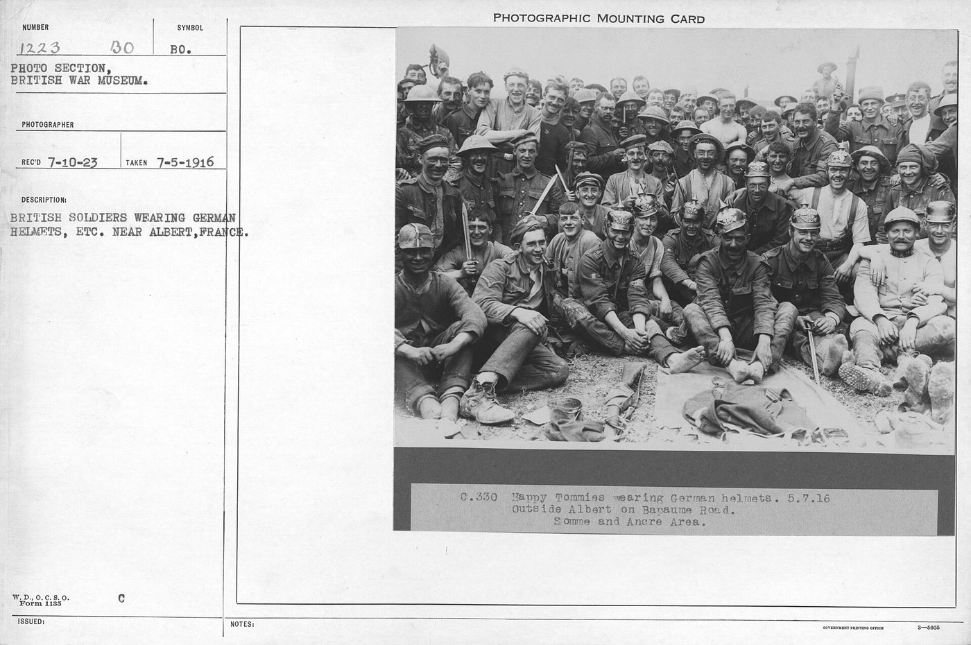 British soldiers wearing captured German helmets as trophies near Albert, France, during the Battle of the Somme, July 1916.