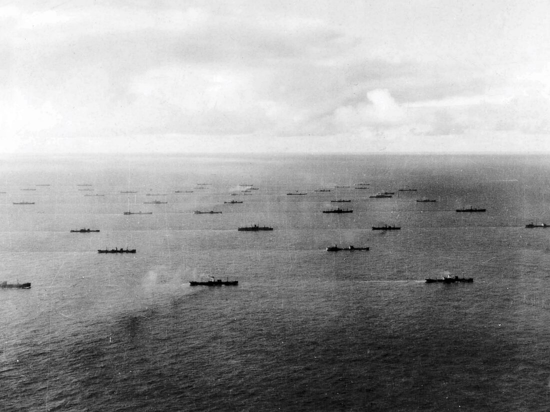 An Allied merchant convoy underway in the Atlantic Ocean near Iceland, circa 1942, ships spread across the water in loose formation.