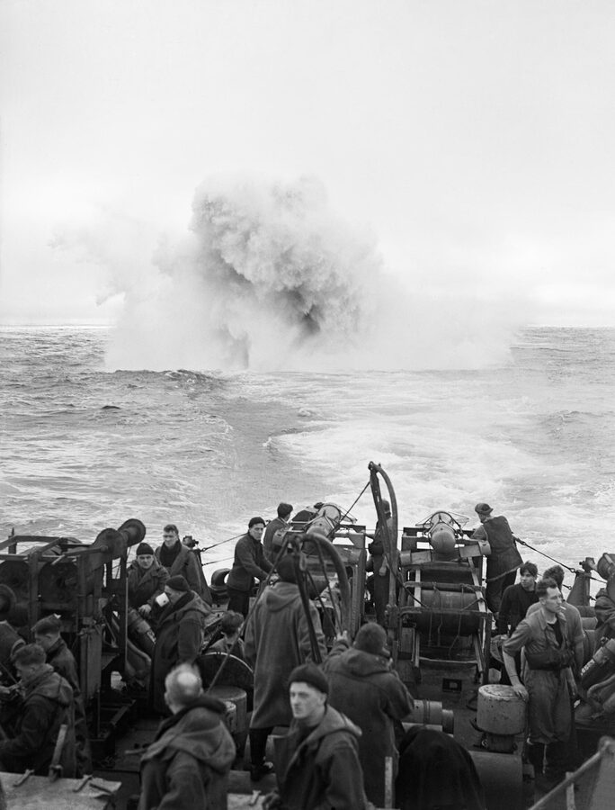 Depth charges exploding astern of HMS Starling, flagship of the 2nd Escort Group, in the Atlantic, January 1944.