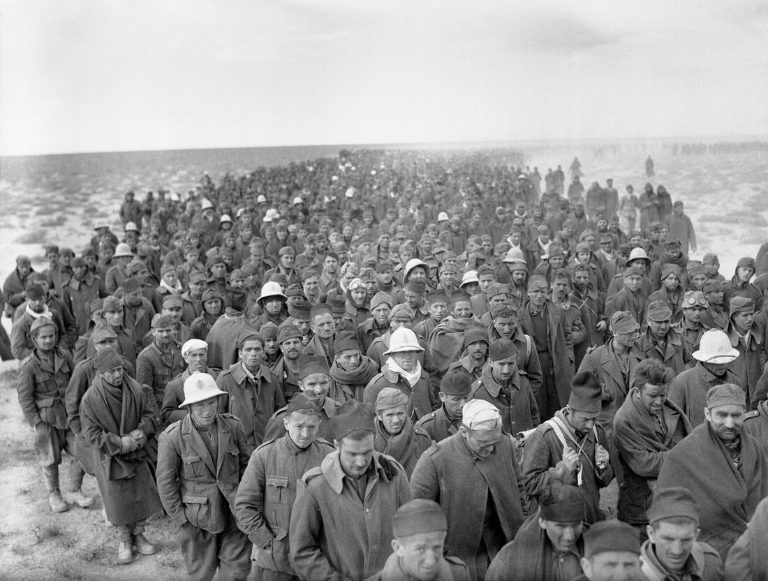A long column of Italian prisoners of war captured during Operation Compass marches to a British army base near Bardia, Libya, January 6, 1941.
