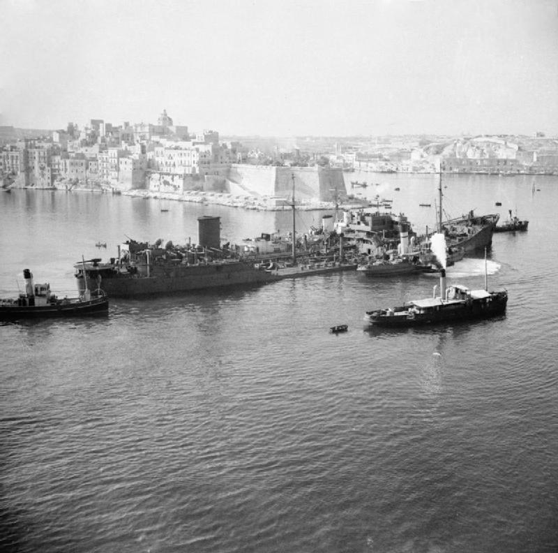 The damaged tanker SS Ohio, supported by two Royal Navy destroyers, approaches Grand Harbour, Malta, August 15, 1942, at the close of Operation Pedestal.
