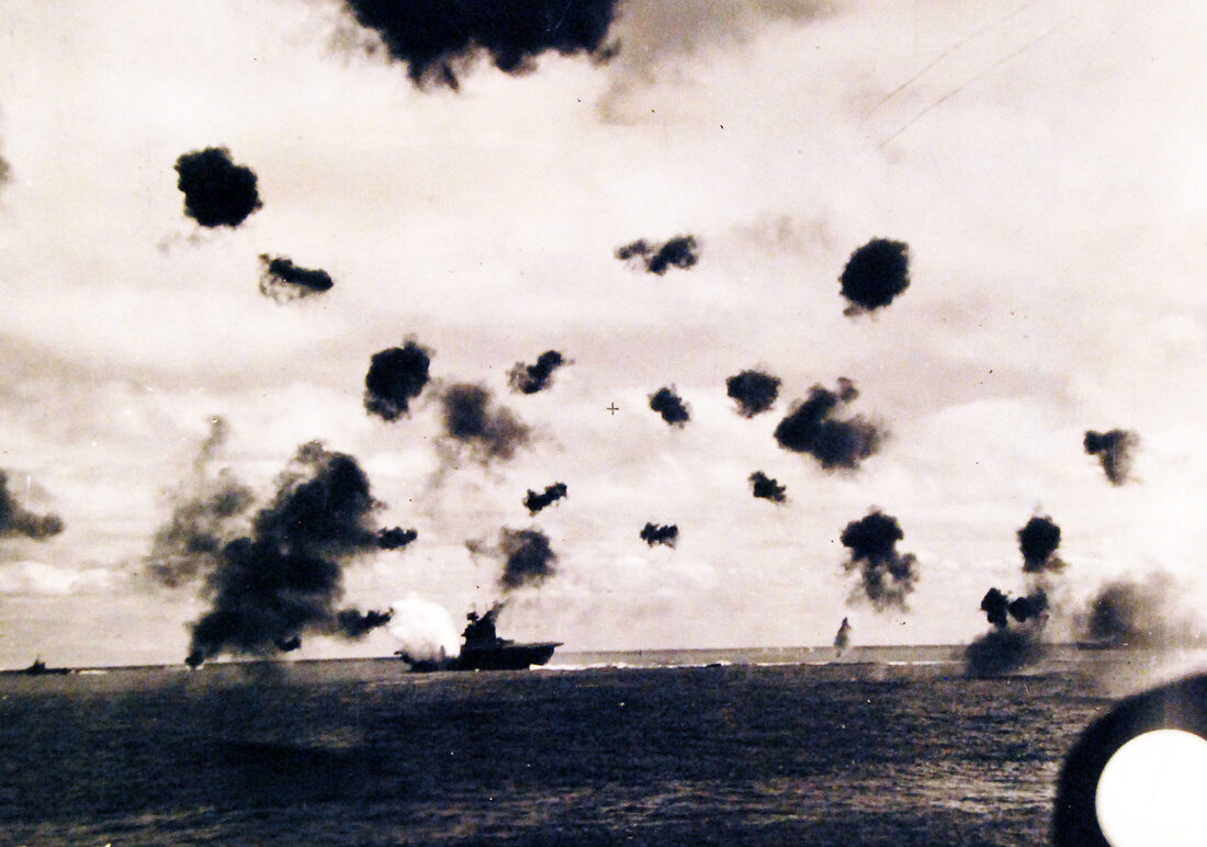 USS Yorktown hit by a Japanese aerial torpedo during the Battle of Midway, June 4, 1942, photographed from USS Pensacola.