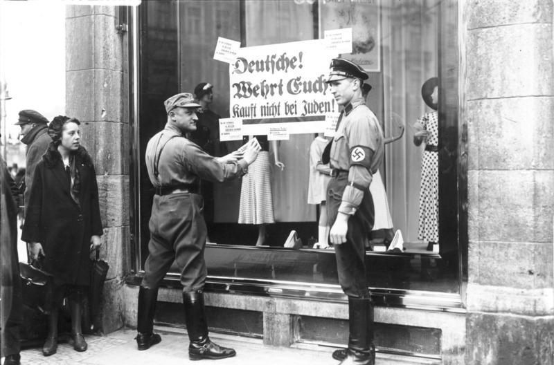 Nazi placards posted on the windows of Jewish-owned shops in Berlin during the national boycott, April 1, 1933.