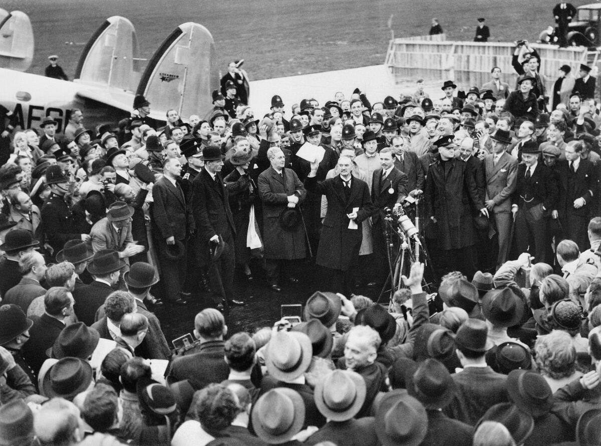 Neville Chamberlain holding up the Anglo-German declaration for the crowd at Heston Aerodrome, London, on his return from the Munich Conference, September 30, 1938.