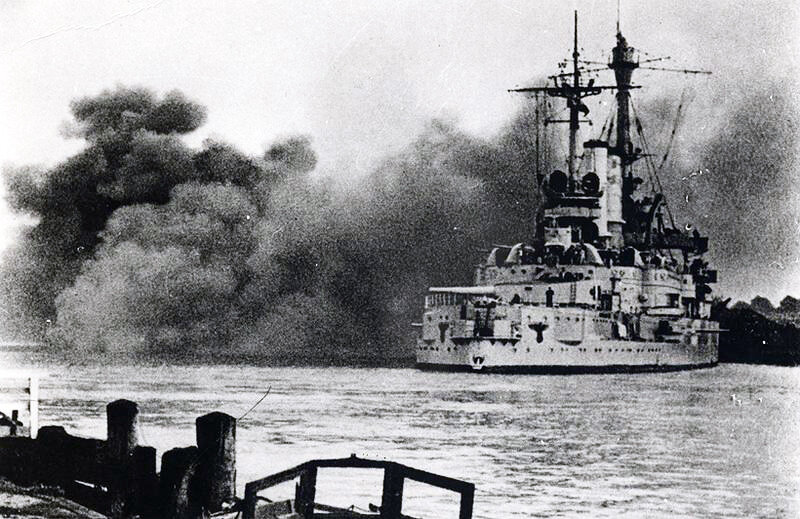 The German battleship Schleswig-Holstein firing on the Polish military depot at Westerplatte, Danzig harbor, September 1, 1939.